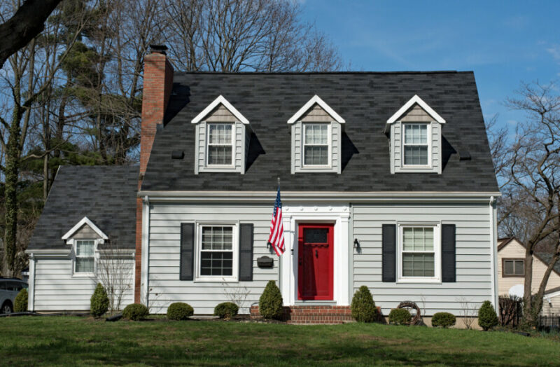 Cape,Cod,House,With,Three,Dormers,&,Red,Door