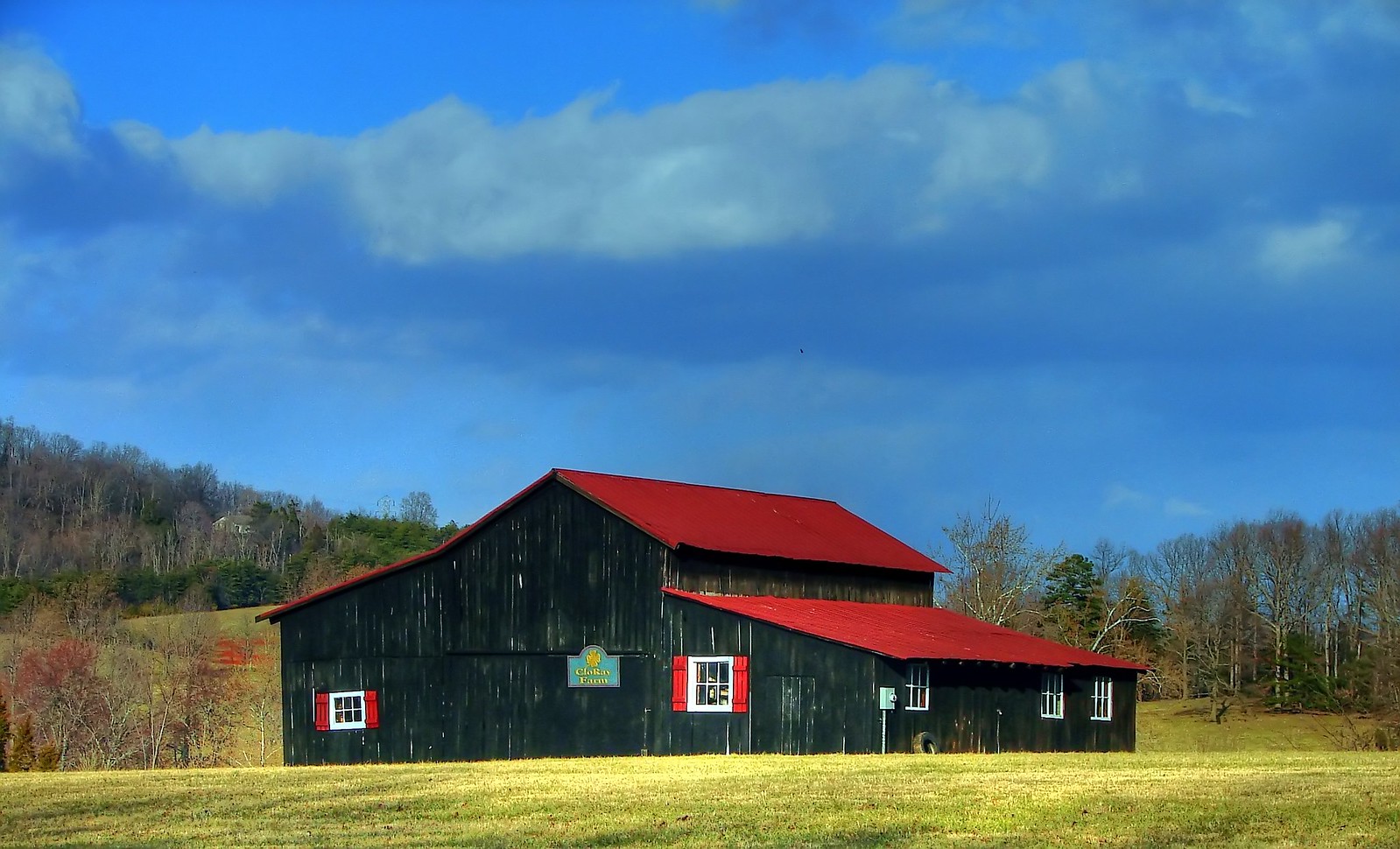 Black Farmhouse with Red Roof