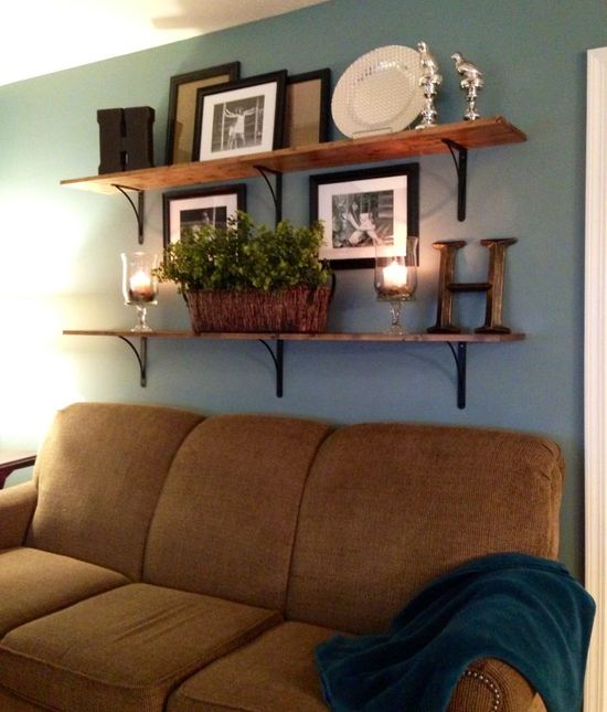 Candles and Flowers on Shelves Behind the Couch