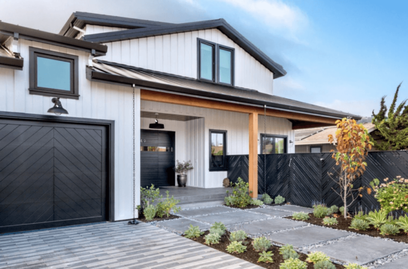 White Home with Black Trim and Wood Deck Support